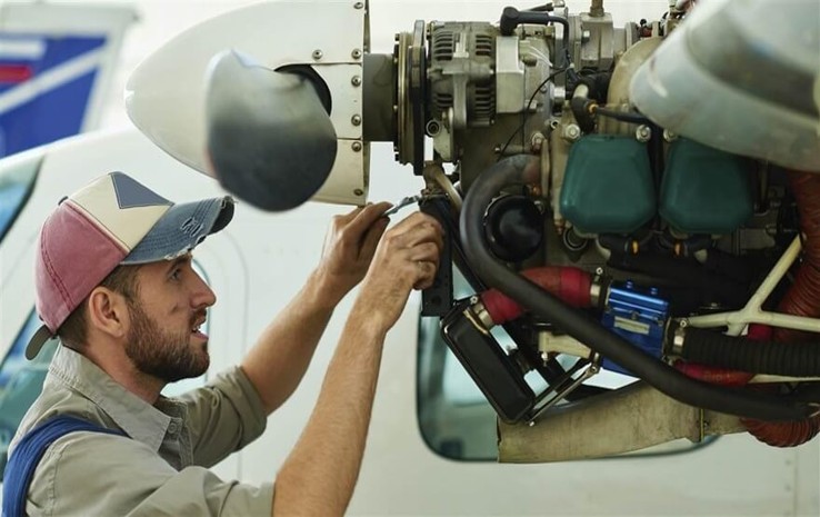 Mechanic inspecting an aircraft engine