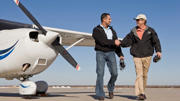 Instructor congratulating a student after a flight
