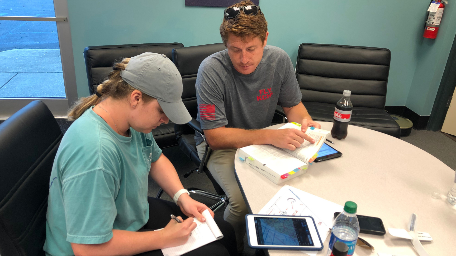 Pilots studying with charts and POH